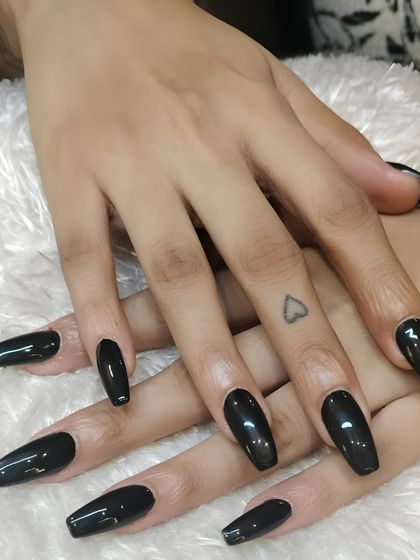 A sleek and striking set of long, black coffin nails. This monochrome look is the epitome of edgy sophistication and confidence.