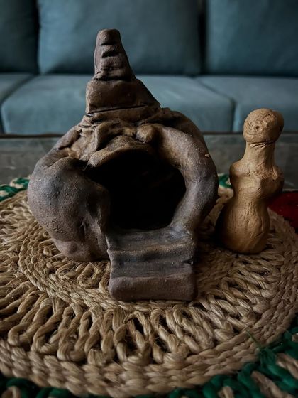 A small, spontaneous temple sculpture my mother made, alongside a little doll my father created. Creativity runs in the family, and these simple forms hold so much love.