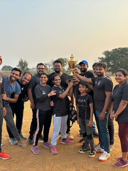 The winning team celebrating with the trophy. Our cricket league is a highlight of the year, bringing everyone together for some friendly competition.