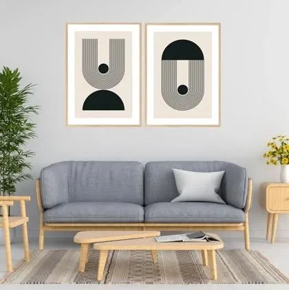 This set of two geometric art prints offers a clean and modern aesthetic. The simple black and white design, shown here in a light wood frame, complements a minimalist or Scandinavian-style interior perfectly.
