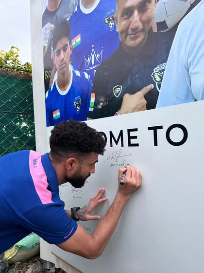 An Odisha FC player signing our welcome board, a tradition for all special guests who visit our home ground.