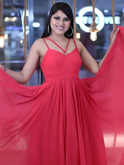 This vibrant pink gown with a strappy neckline is fun, flirty, and perfect for a pre-wedding shoot with a playful vibe.