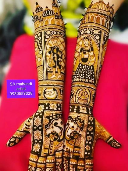 This design features portraits of a couple in a playful mood. The arms are decorated with peacocks and palace architecture.