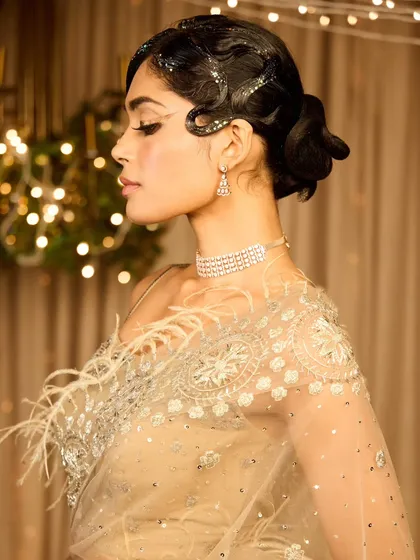 A collection showcasing a unique vintage cocktail look. The glitter-parted finger wave hairstyle and dramatic graphic eyeliner create a memorable and high-fashion statement.