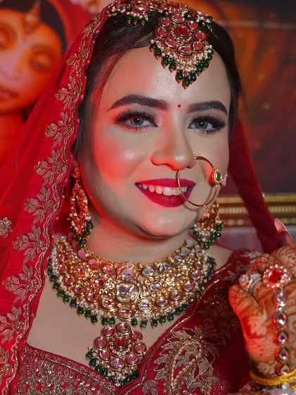 A happy bride is the prettiest bride. Her smile says it all. This close-up showcases the flawless base, bright red lipstick, and perfectly defined eyes.