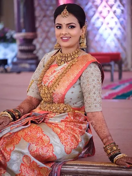 A bride in a beautiful two-tone saree. Her custom blouse is fully embroidered with gold thread, creating a look of classic elegance.
