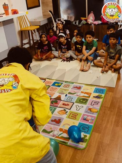 A professor engages a group of kids during a summer camp session. We keep our groups focused to ensure every child gets attention and can participate fully.