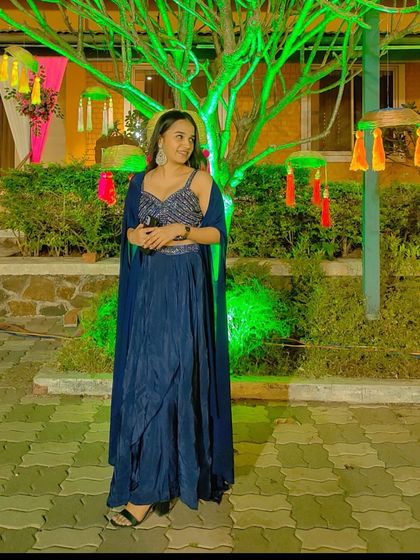 Another angle of the navy blue cape set, showing how the cape drapes gracefully over the shoulders. This outfit is perfect for making a subtle yet impactful style statement.