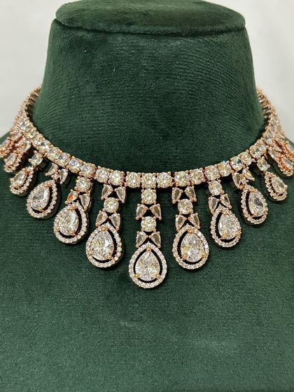 A close-up of a rose-gold plated American diamond choker. The warm finish makes this rental piece stand out.