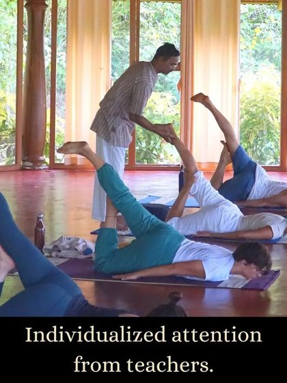 Personalized guidance is a hallmark of our training. An instructor offers a hands-on correction during an asana practice, ensuring each student understands the alignment and feels supported in their journey.
