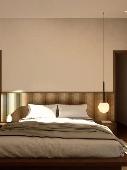 This bedroom in Kumo House is a restful retreat, featuring a low-profile bed and a fluted wood headboard. A single pendant light adds a touch of elegance and provides soft, ambient illumination.