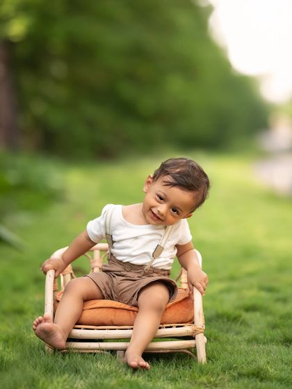 A cheeky little head tilt and a sweet smile from this toddler. His personality really shines in this relaxed outdoor portrait.