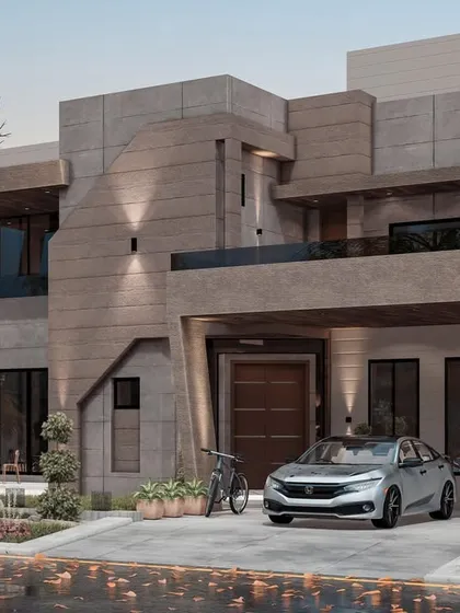 This design demonstrates our ability to work with bold, contemporary forms and materials. The angular concrete facade, strategic exterior lighting, and large glass panels create a powerful architectural statement that is both modern and timeless.