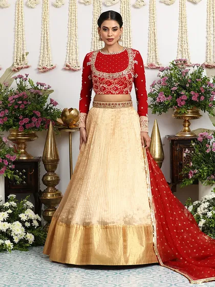 The complete ensemble, including the red Bandhani dupatta, creates a stunning and cohesive bridal look.