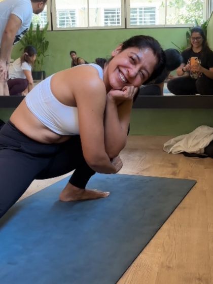 A happy, smiling face during a deep stretch. This is what it looks like to enjoy the process of getting stronger and more flexible.