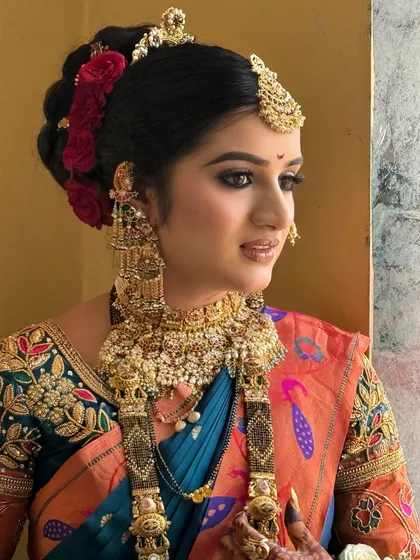 A close-up of the bride's makeup and heavy gold jewellery, showing the intricate details.