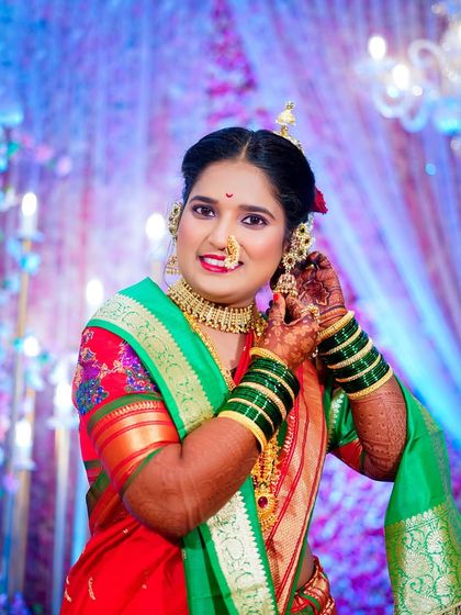 A lovely getting-ready shot of the bride adjusting her earring. This captures a moment of final touches, with her happy expression reflecting the joy of the day.