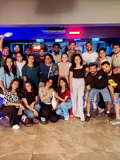 This is what it's all about: good times with great people. A large group of friends celebrates together after a fun-filled bowling session, capturing the perfect squad hangout vibe.