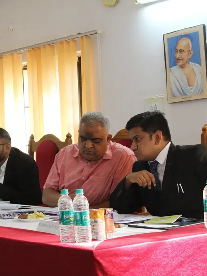 A portrait of Mahatma Gandhi overlooks the proceedings as I judge the human rights-themed moot court at NLU Jodhpur.