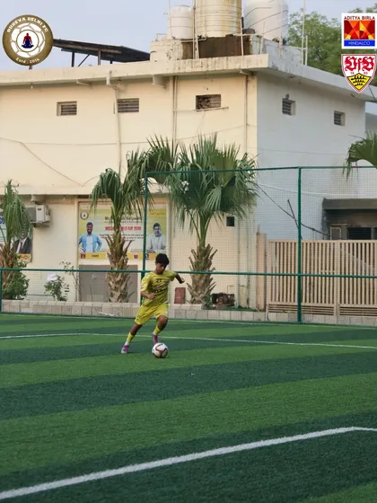 Dribbling practice is a core part of our curriculum. Here, a young player works on his close control and agility.