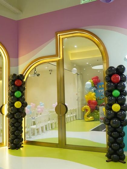 Balloon columns designed to look like traffic lights add a creative touch to this car-themed party entrance.