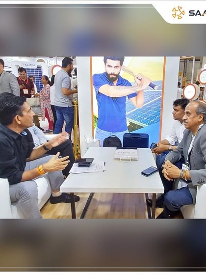 Our team discussing business opportunities with partners at the REI Expo, with our brand campaign in the background.