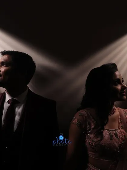 A dramatic engagement portrait using spotlights to create a cinematic effect. This technique highlights the couple while keeping the background dark, adding a touch of glamour.