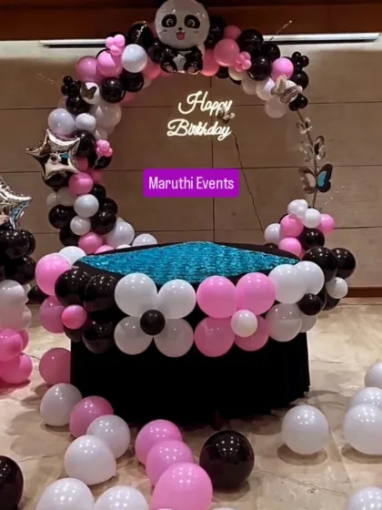 A cute panda-themed party with a black, white, and pink color scheme. The balloon-filled table is surrounded by a balloon arch topped with a panda foil balloon.