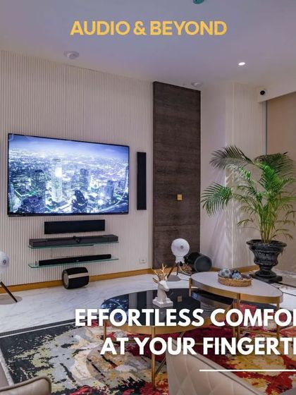 Effortless comfort at your fingertips. This living room setup features a complete surround sound system with tower and satellite speakers, all integrated with smart home controls for a seamless entertainment experience.