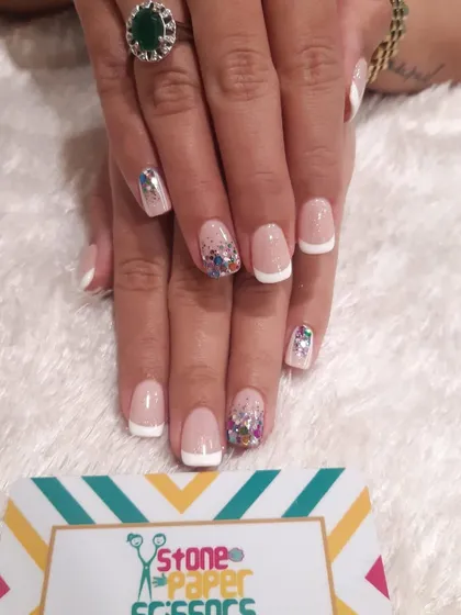 A fun party nail look. I started with a classic French manicure on short square nails and added accent nails with a burst of colorful glitter confetti.