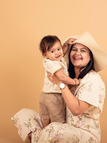 A heartwarming and candid moment between a mother and her child. Her genuine laughter and his happy expression make this photo truly precious.