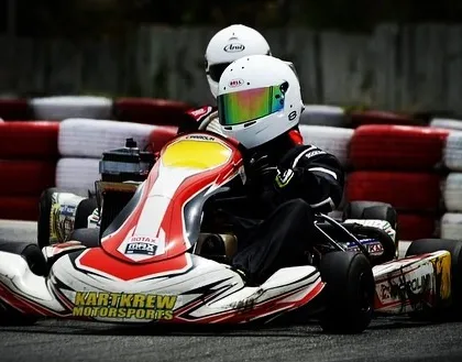 Two drivers in our older liveried karts, showcasing our journey through the years.