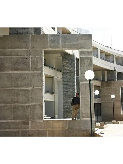 At the IIM Bangalore hostel, we used large openings and framed views to break down the building's mass. This approach maintains a human scale and visually connects the interiors with the surrounding landscape, making the structure feel integrated and approachable.