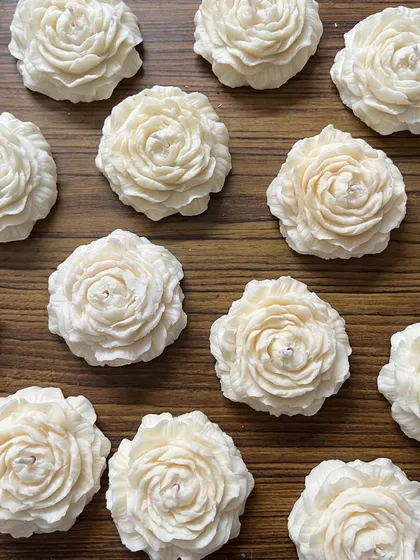 Our peony candles are a perfect gift. This image shows them unboxed, highlighting the intricate floral detail.