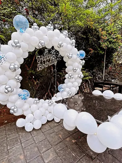 Another view of the outdoor white and silver balloon ring, showing how it can be integrated with existing furniture for a cohesive party look.