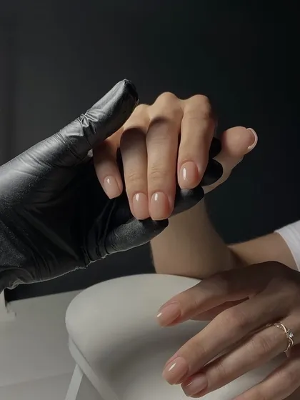 A shot showing the trust between a client and our nail tech, holding hands as we prepare the nails for a beautiful manicure.