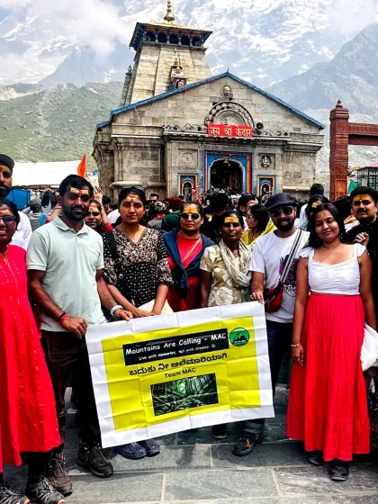Our group at the Kedarnath temple, holding our banner with pride. We successfully complete multiple batches for this spiritual yatra every year.
