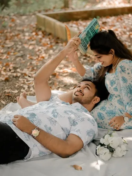 A playful and intimate moment from their picnic shoot. This unique angle and their happy expressions make for a fun and memorable photograph.