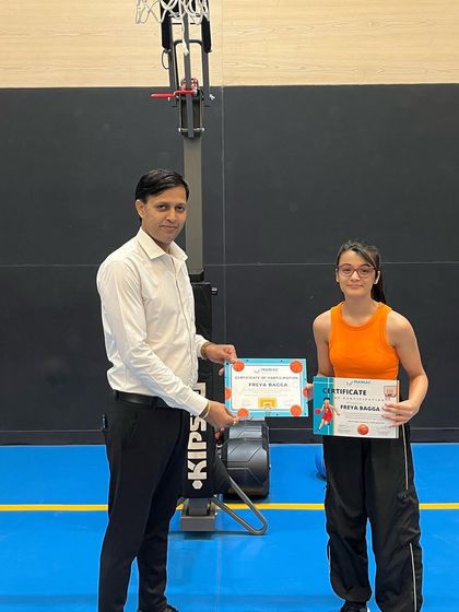 A player receives her summer camp certificate. We make sure to recognize the progress and dedication of every participant.