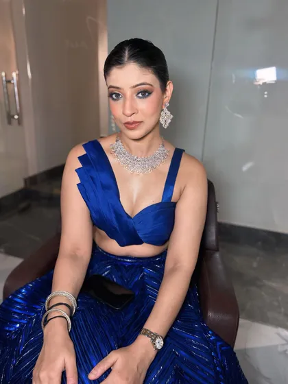 A direct look at this striking party makeup. The intense eye makeup is balanced with a flawless base and a neutral lip, letting her eyes do all the talking.