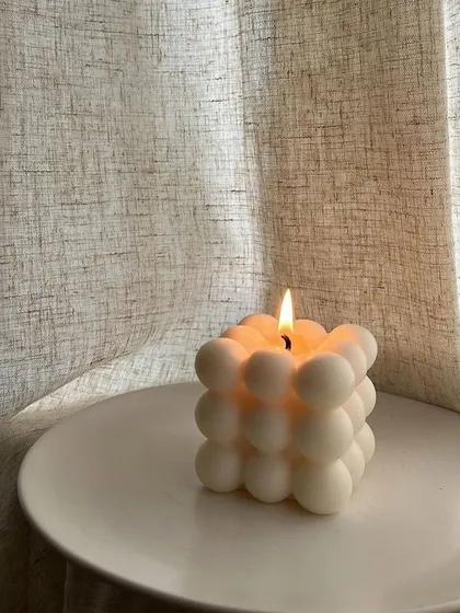 A single bubble candle lit on a white tray, creating a cozy and minimalist mood. Perfect for a quiet evening.