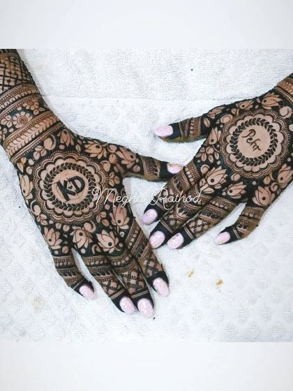 This design incorporates the couple's initials 'K' and 'D' as well as the name 'Pehr' into central mandalas, surrounded by dark, bold floral work.