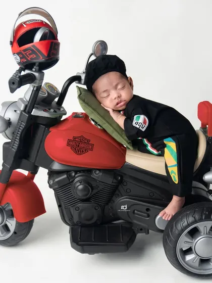 Even bikers need a nap. This little guy is sleeping right on his motorcycle.