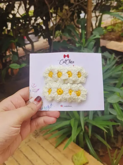 A set of our cheerful daisy clips, perfect for a sunny day. The white petals and yellow centers are all crocheted by hand.