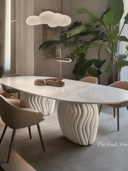 This design showcases what's possible with custom furniture. An oval marble dining table rests on unique, wave-like sculptural bases, creating a piece of functional art that is both modern and organic.