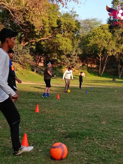 A young player focuses on his next move during a dribbling exercise. We create a supportive space where kids can practice and perfect their individual football skills.