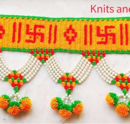 A close-up of the Swastik pattern toran, showcasing the neat stitching and vibrant, festive colors.