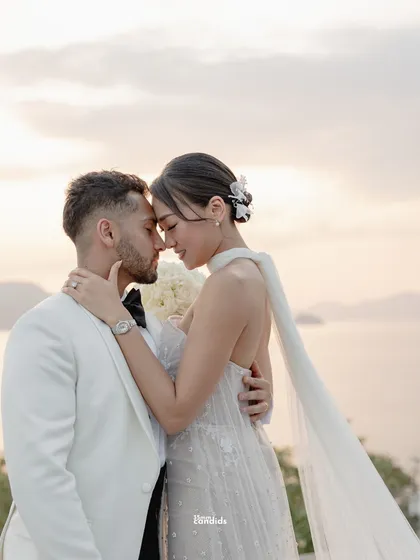 An intimate close-up of the couple, foreheads together, after their vows. This is the quiet moment after the public declaration, a breath shared between two people in love.