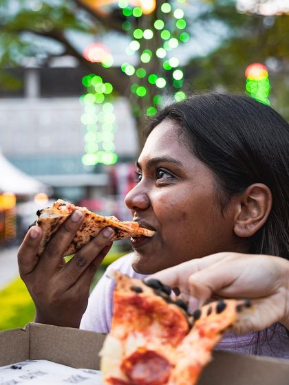Another happy customer enjoying a slice. Our goal at any event is to serve up countless moments of delicious satisfaction.