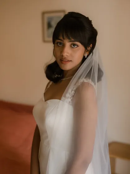 A beautiful portrait of Shruti with her veil. The soft makeup and elegant hairstyle create a timeless and romantic bridal look.